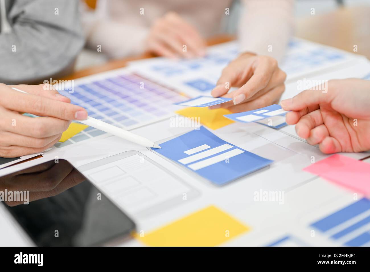 Team of mobile application designer and developer are in the meeting, discussing and brainstorming the interface design. cropped and close-up image Stock Photo