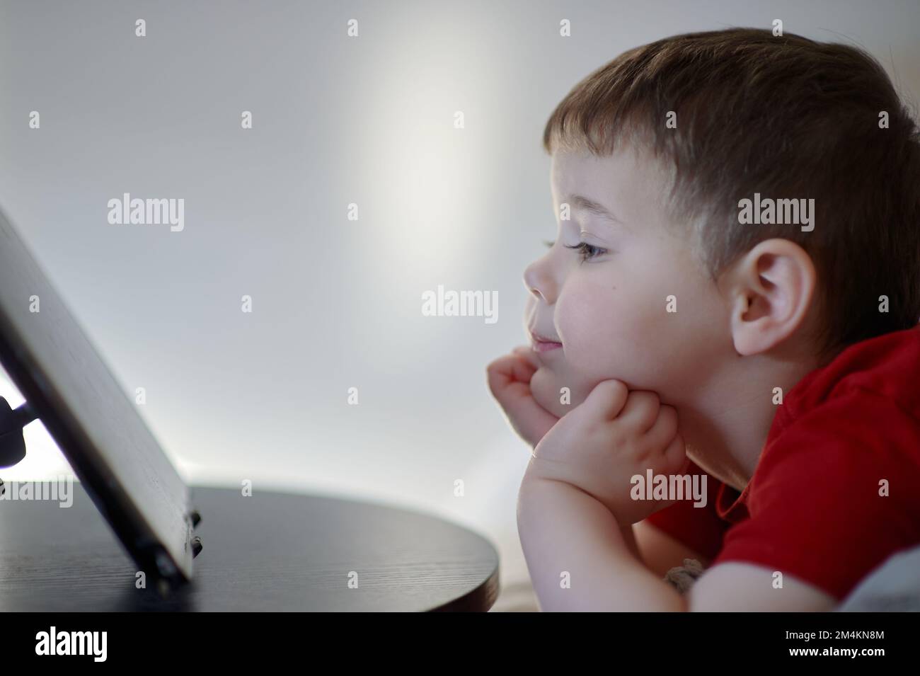 beautiful boy watching cartoons on a table top tablet Stock Photo