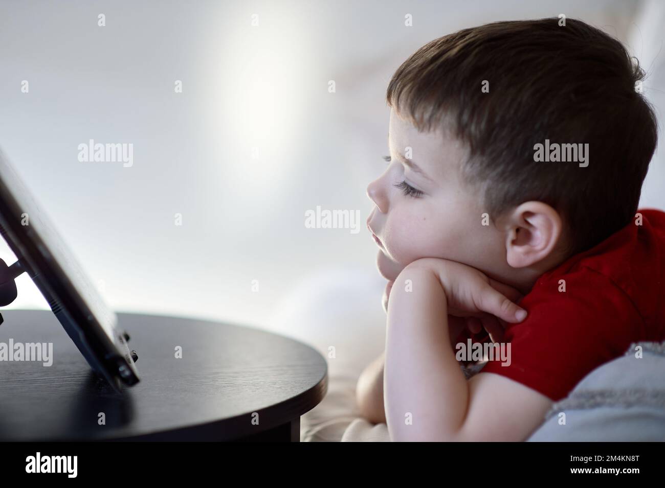 beautiful boy watching cartoons on a table top tablet Stock Photo
