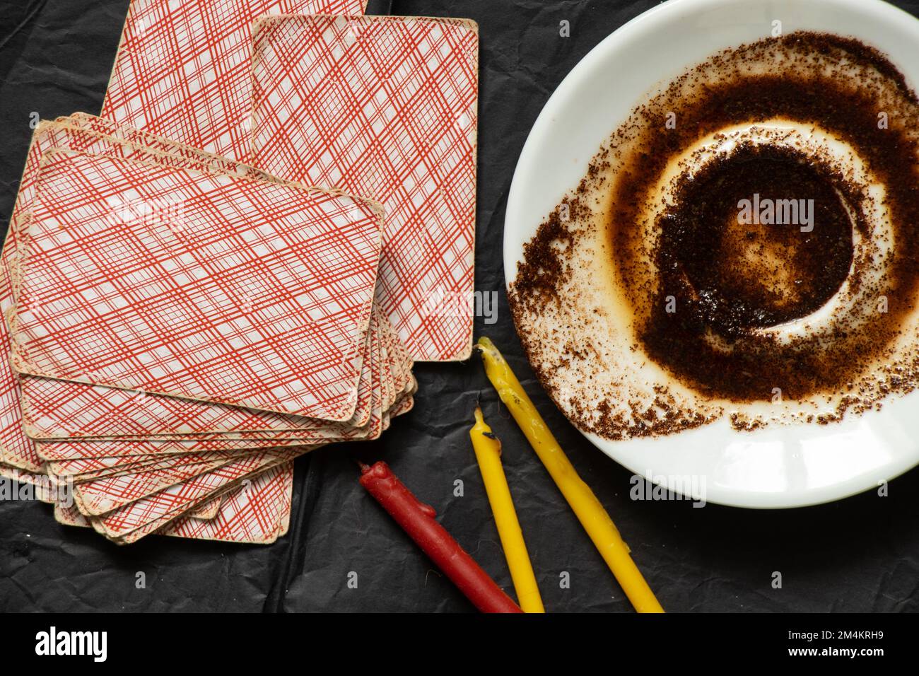 coffee grounds in a saucer and cards and candles on the table, fortune telling and prediction