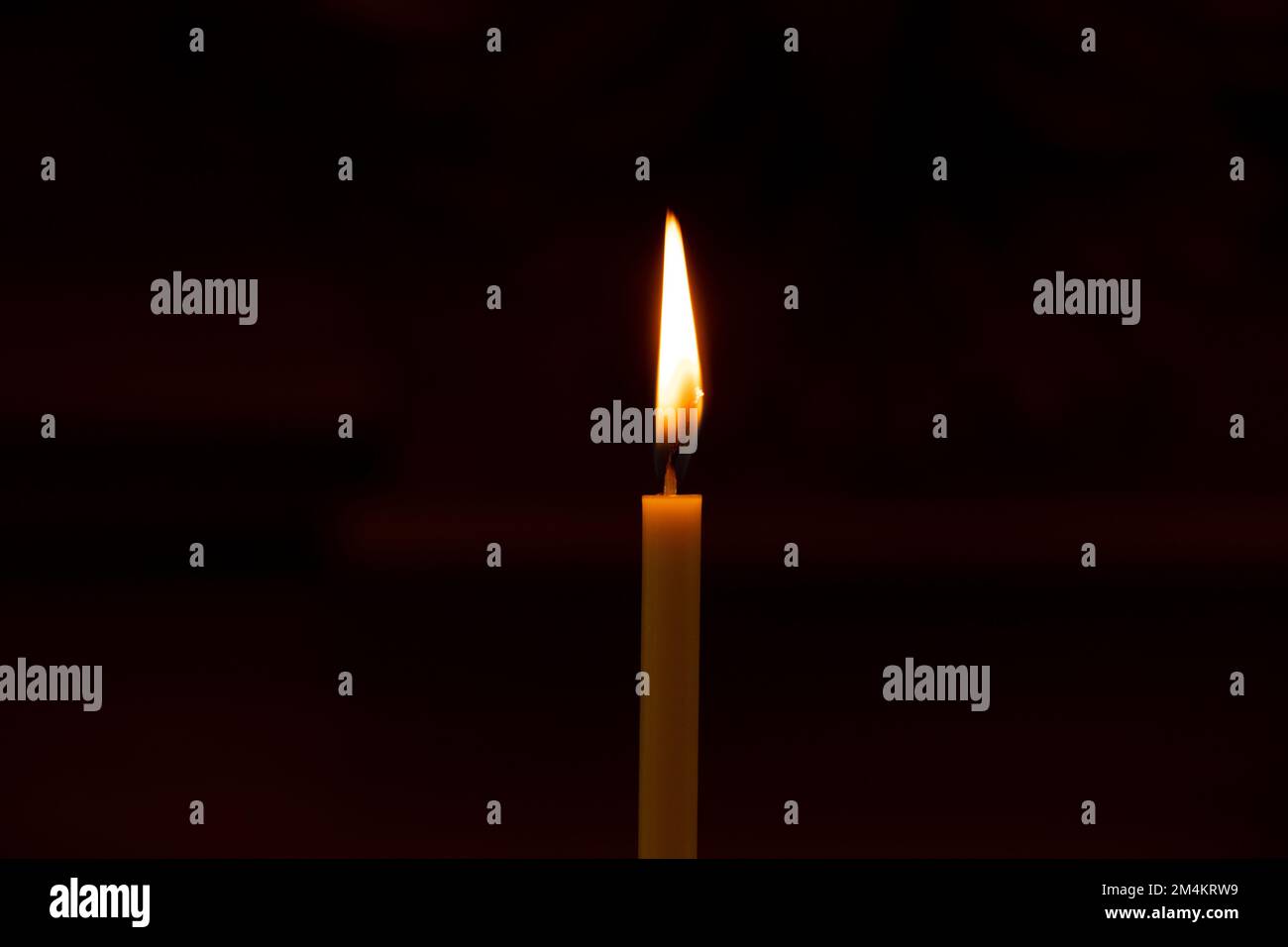 candle flame in the dark in the church, burning candle, religion Stock