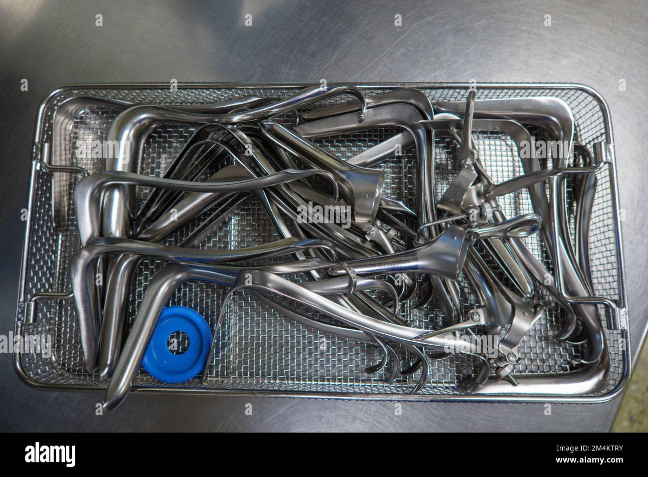 many different gynecological specula are cleaned and disinfected in a