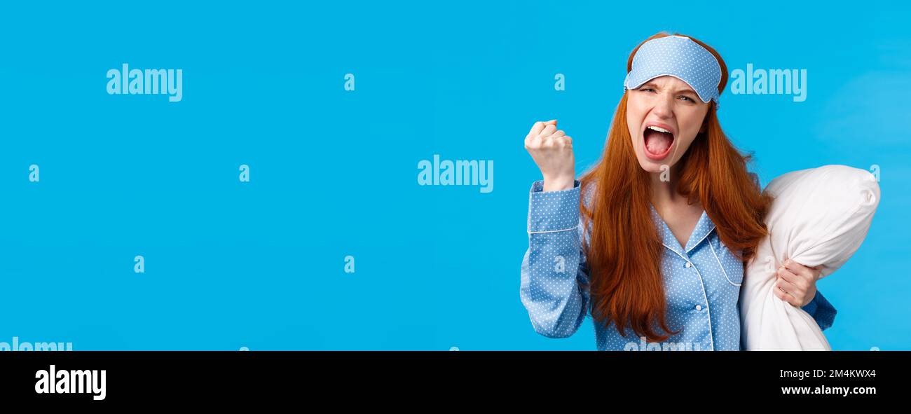 Mad, outraged and furious redhead caucasian girl shouting, cursing
