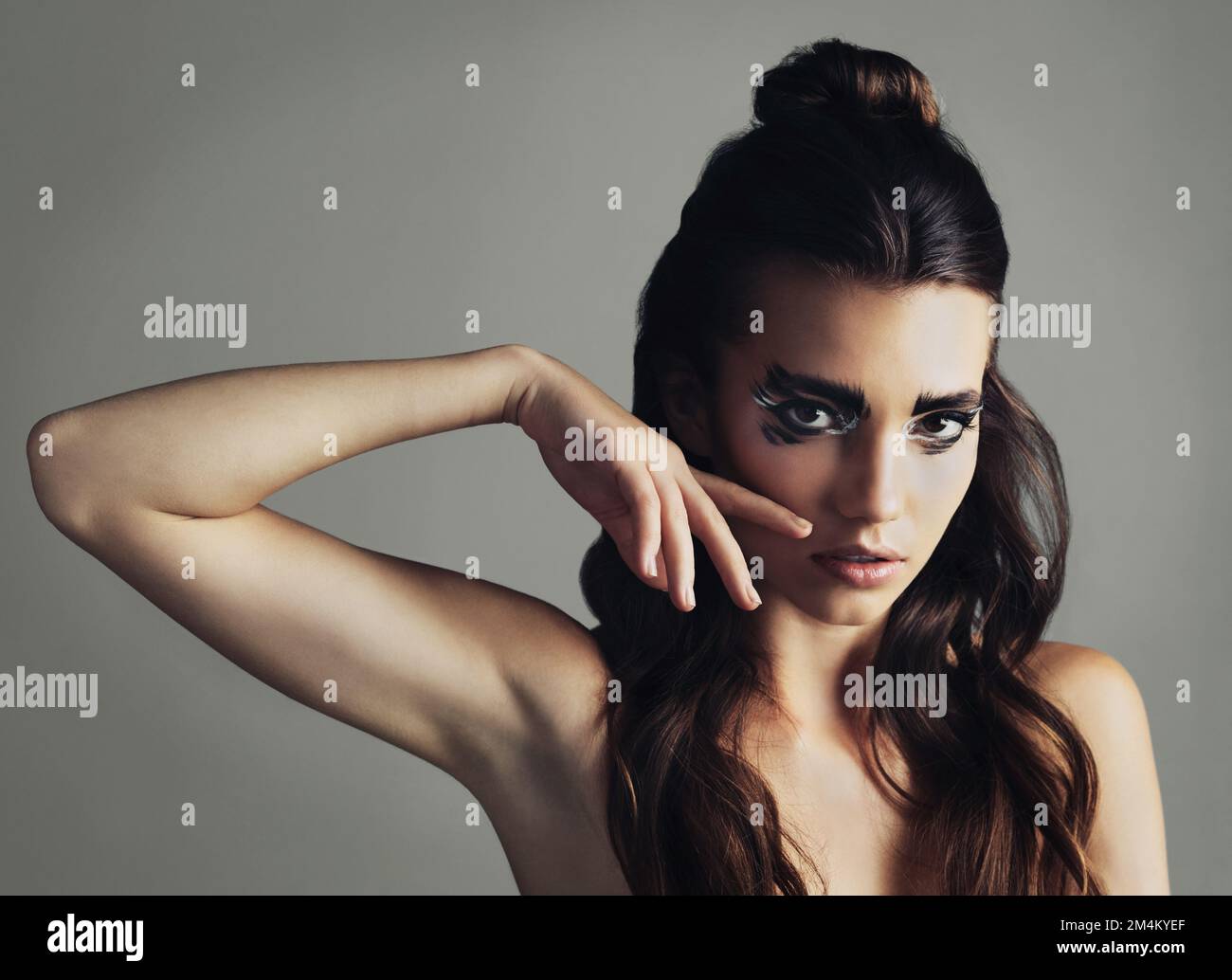 Be your own inspiration. Studio shot of an attractive young woman wearing bold eye makeup. Stock Photo