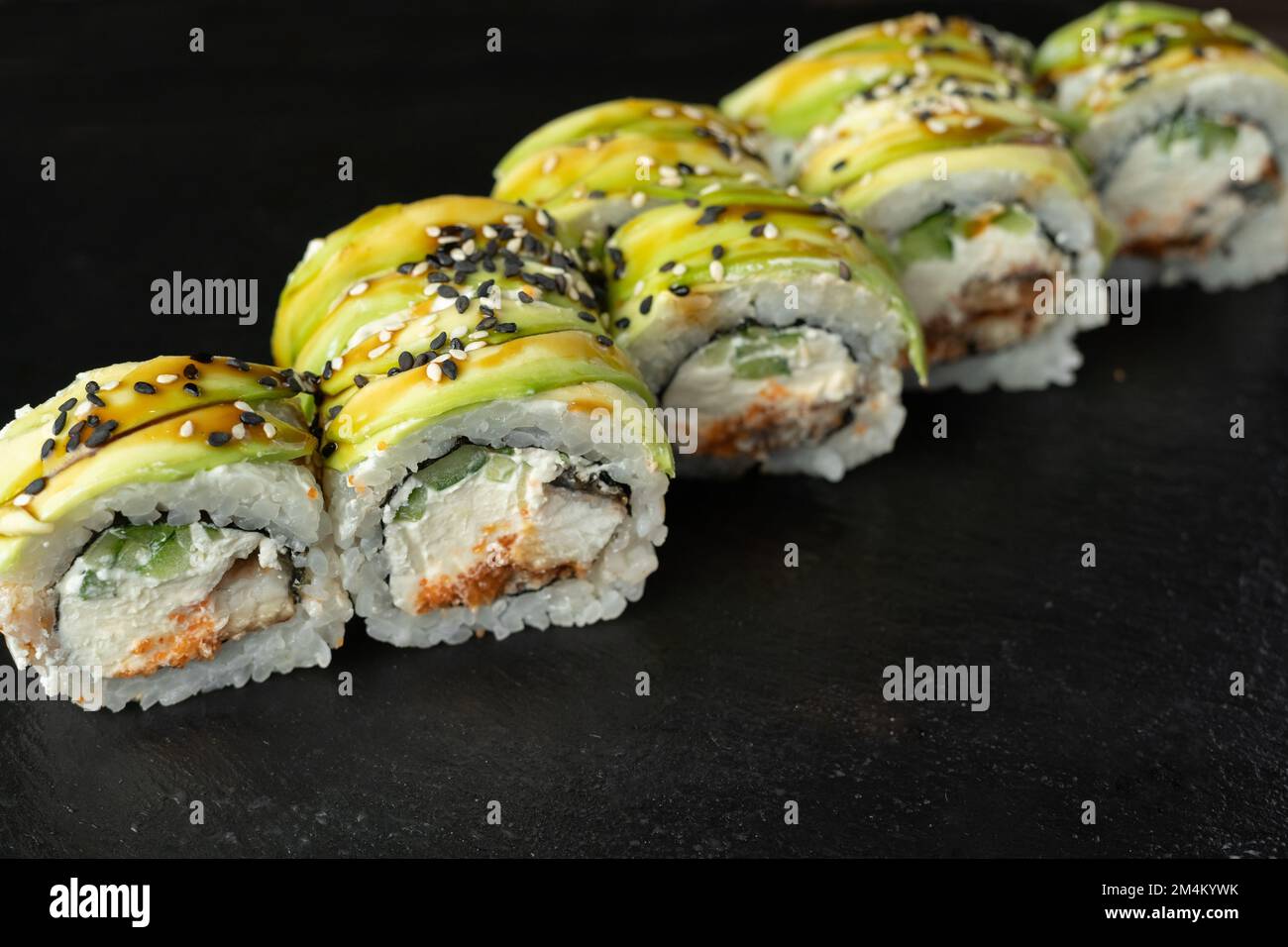 Indlejre glide Isbjørn Sushi rolls japanese food over black background. Sushi roll with salmon,  cream cheese and avocado close up. Japan restaurant menu. Top view Stock  Photo - Alamy