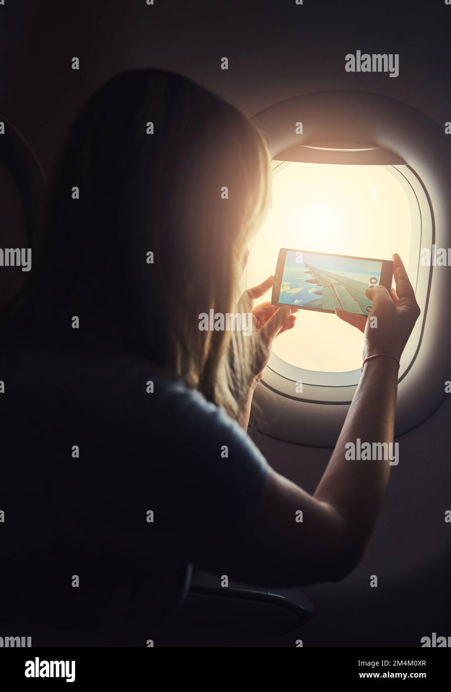 Too beautiful not to capture. a young person in an airplane. Stock Photo