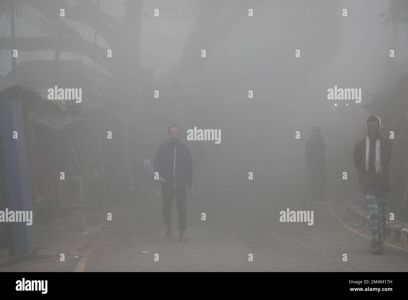 People go to their workplace in a foggy winter morning in Munshiganoj ...