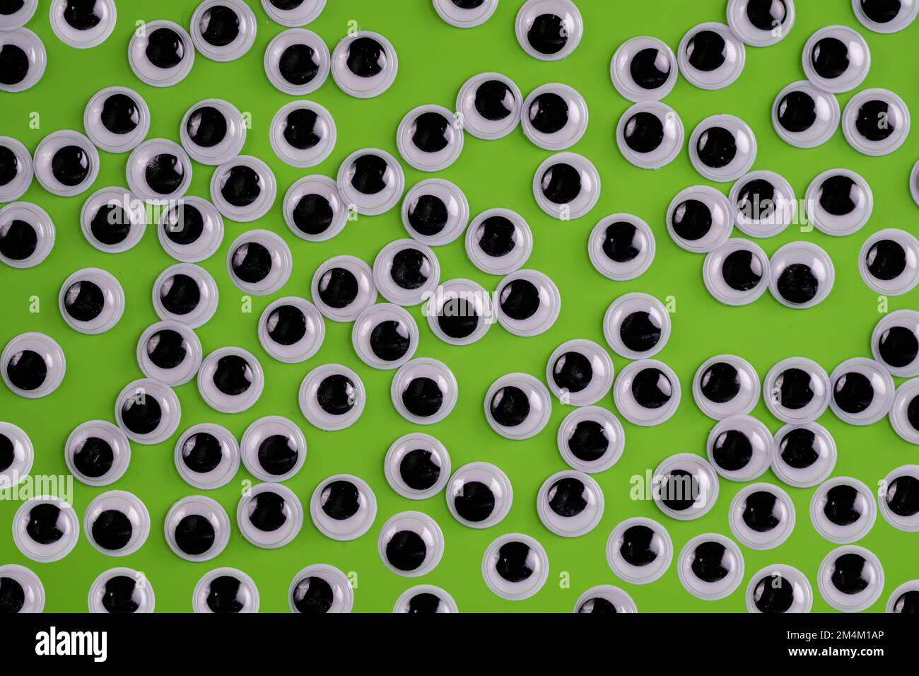 funny googly eyes isolated on a green background Stock Photo - Alamy