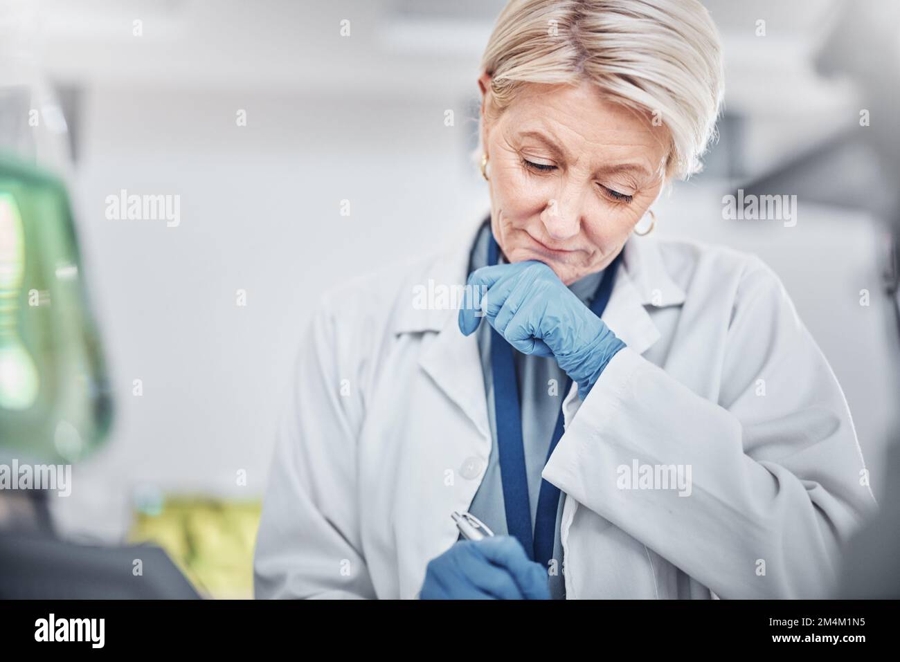 Science, research and senior woman writing notes on documents in laboratory. Innovation, thinking and elderly female scientist researching, recording Stock Photo
