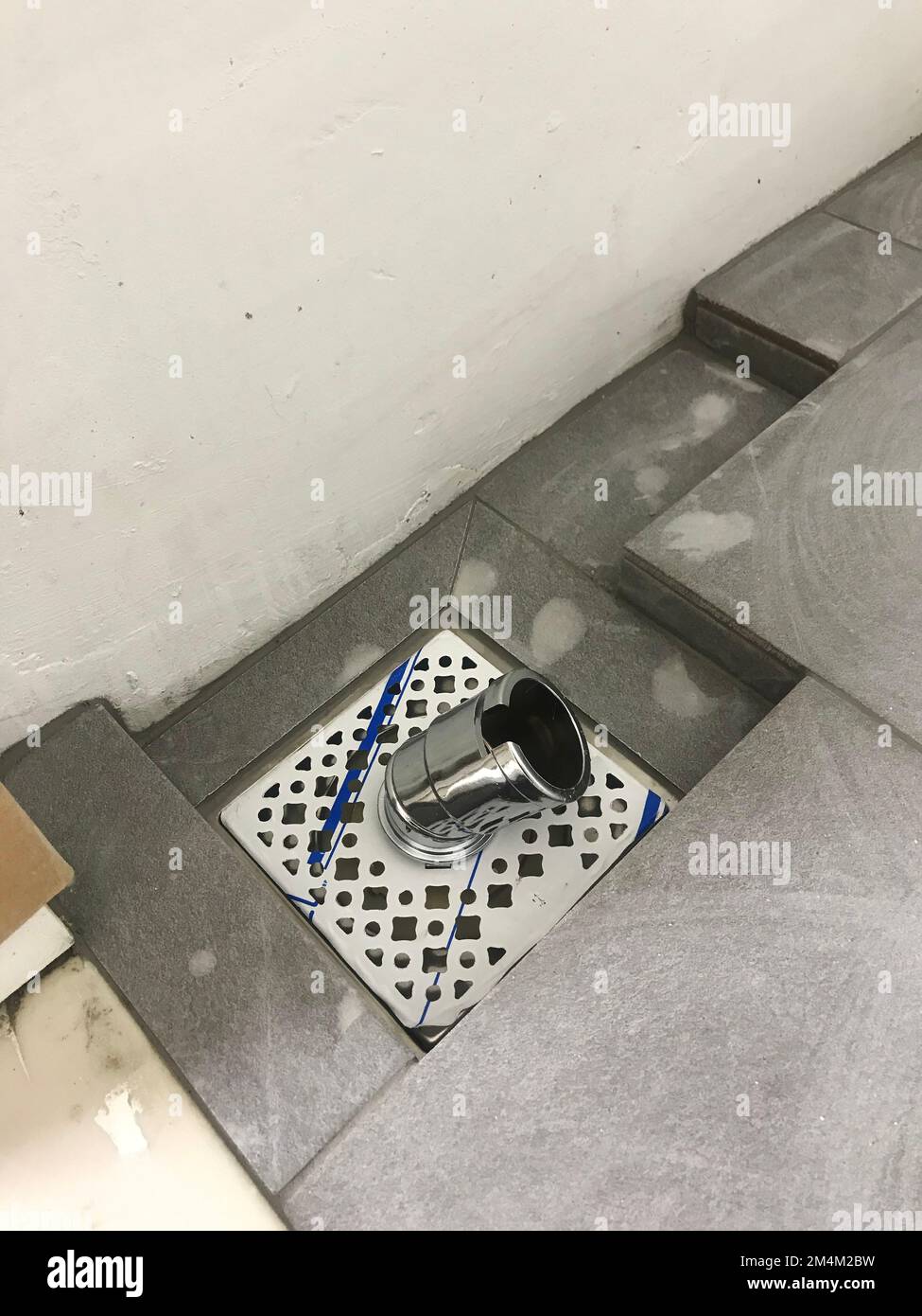 The floor tiles and drain of laundry room Stock Photo Alamy