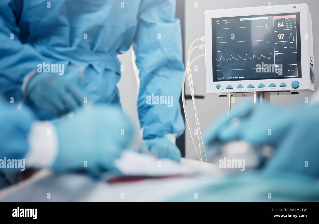 Hands, monitor and operation with a team of doctors at work during surgery with equipment or a tool in a hospital. Doctor, nurse and collaboration Stock Photo