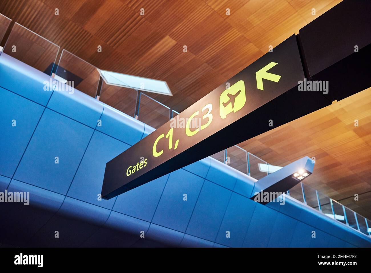 This is where you need to be. a sign directing you where to go at the airport. Stock Photo
