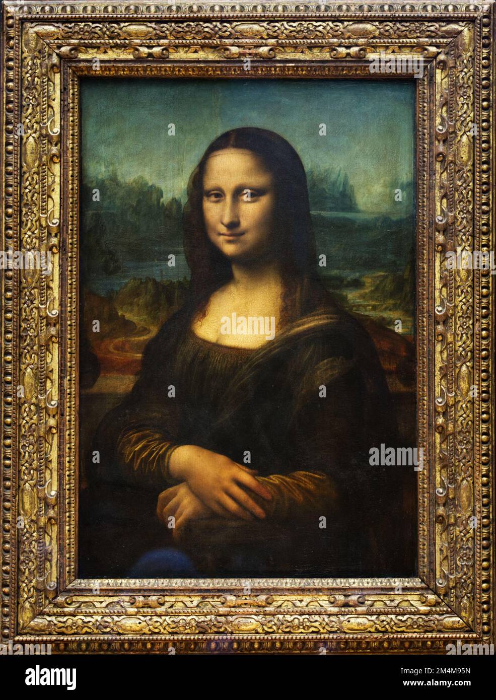 A closeup of the portrait of Mona Lisa located inside the Louvre Museum