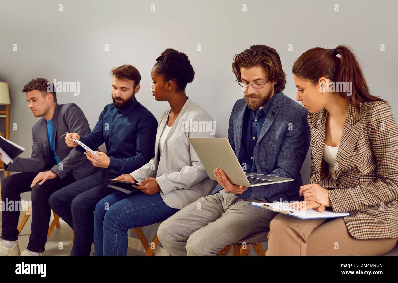 Colleagues talk to each other discussing work issues and information heard during business seminar. Stock Photo