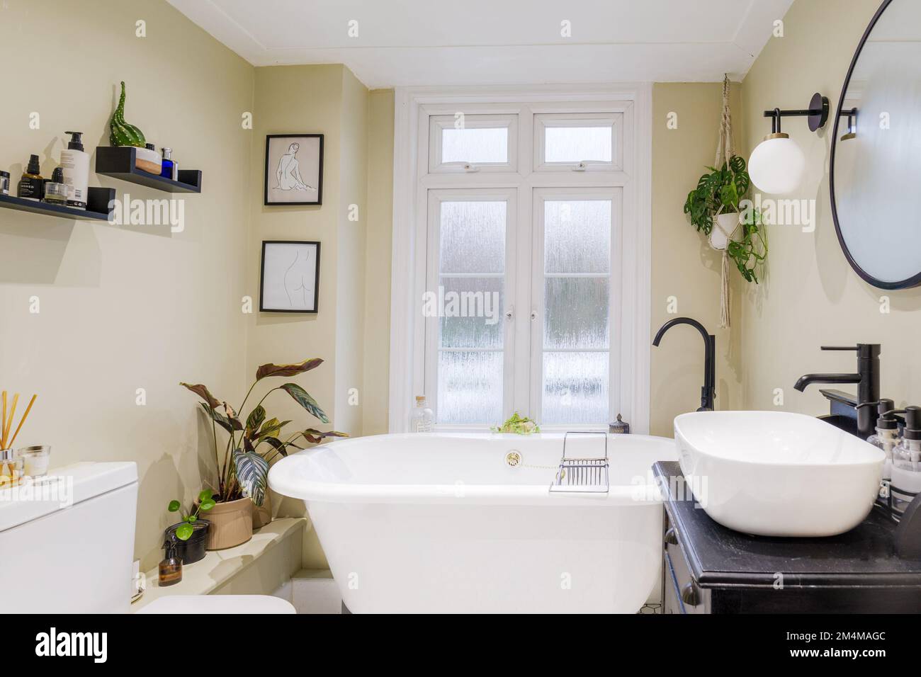 A boutique hotel bathroom with freestanding bath and contemporary decor ...