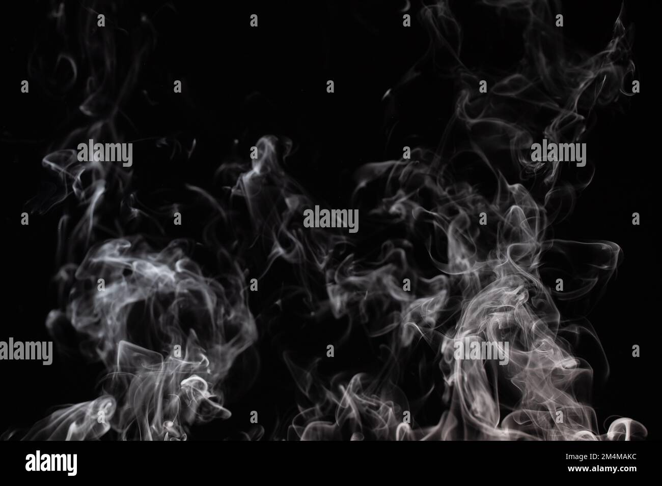 Graphic background with curls of white smoke on a completely black wall