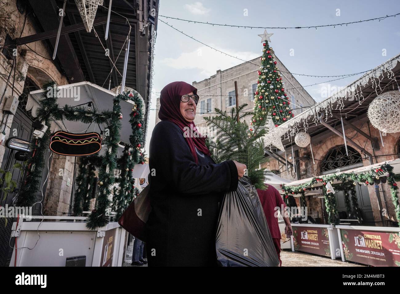 Jerusalem, Israel. 22nd Dec, 2022. The Jerusalem Municipality and the Jewish National Fund distribute specially grown Arizona Cypress Christmas trees to the Christian population at the Old City's New Gate. Credit: Nir Alon/Alamy Live News Stock Photo