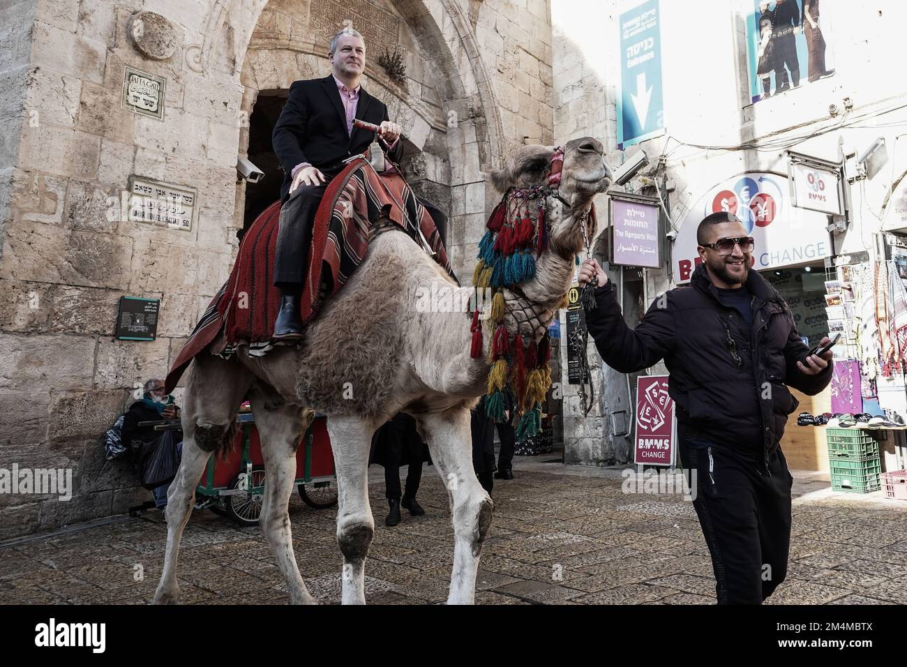 Jerusalem, Israel. 22nd Dec, 2022. GEORGE NOLL, Chief Of The U.S. Office Of Palestinian Affairs, rides a camel at the Old City's Jaffa Gate. Credit: Nir Alon/Alamy Live News Stock Photo