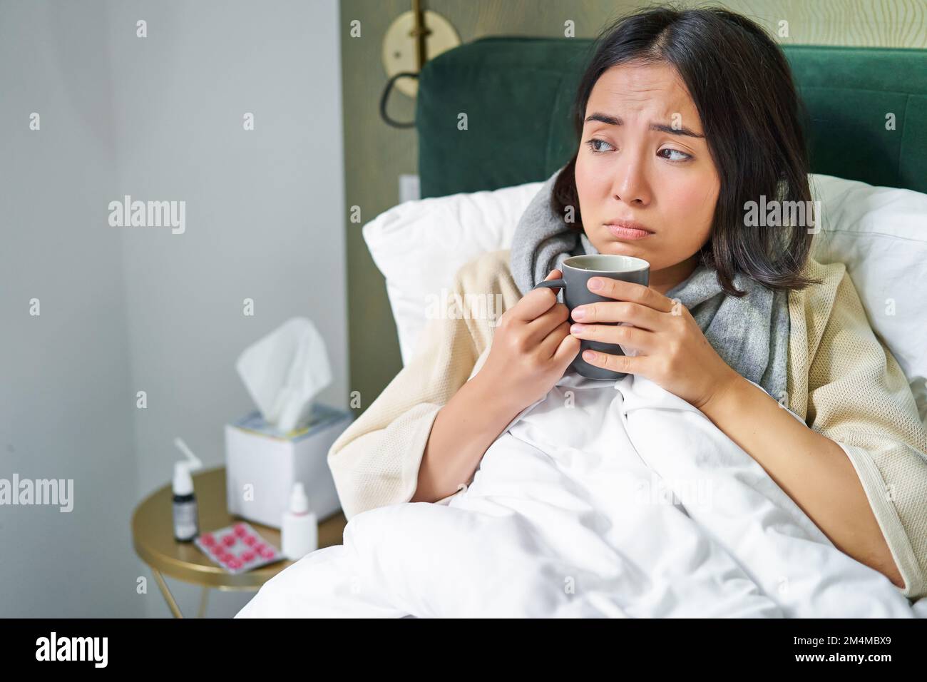 Covid19, flu and vaccination concept. Korean girl lying in bed with