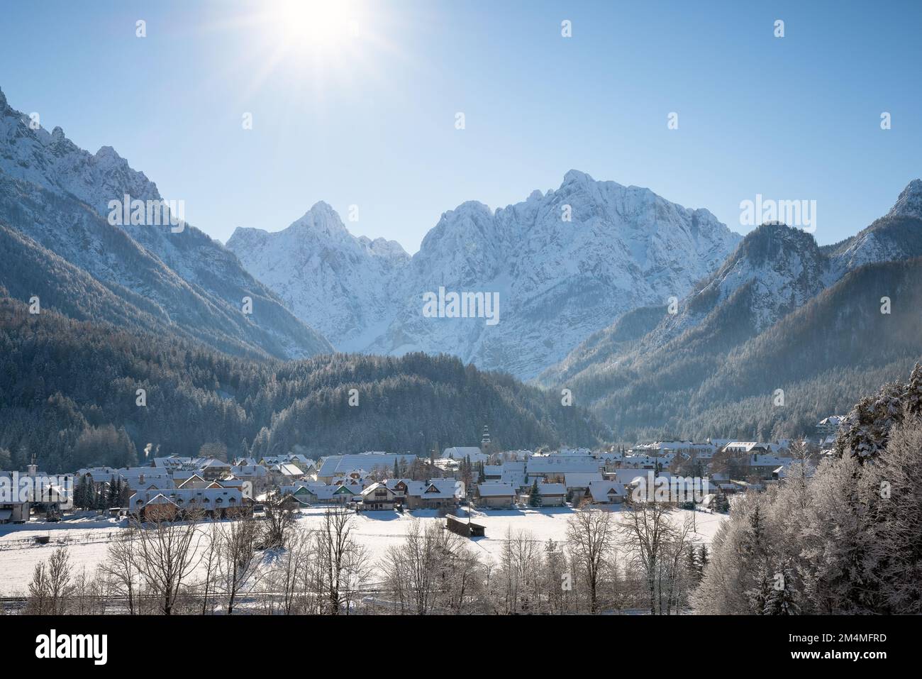 Kranjska Gora in Slovenia covered in snow at winter with Julian Alps and Triglav National Park in the background Stock Photo