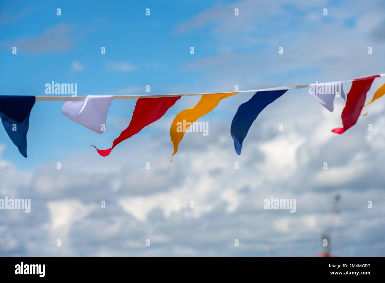 Colorful Flag Ropes Colorful flags hanging on the rope against scenic cloudy sky background ...