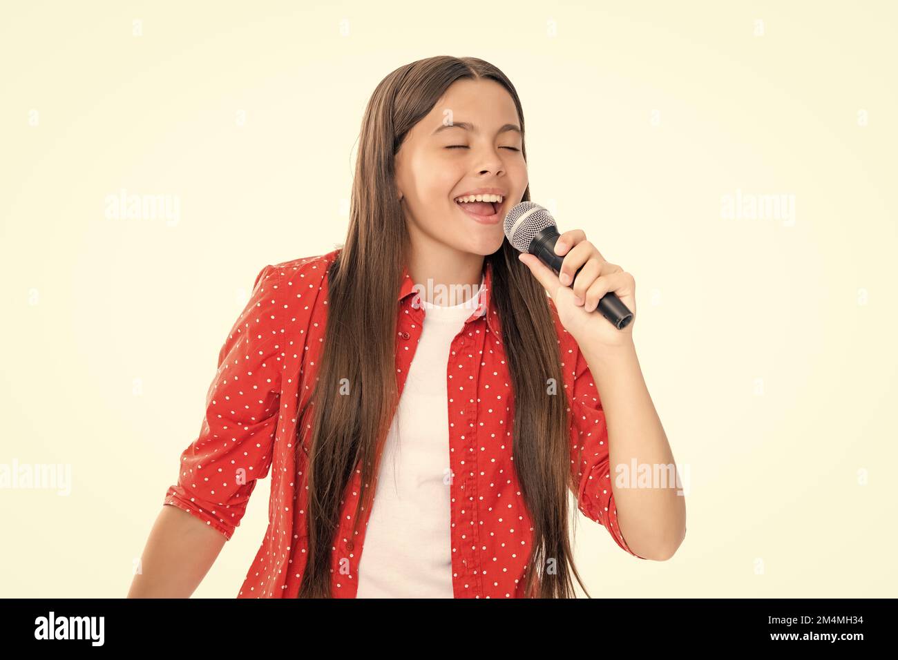 Child girl holding wireless microphone for karaoke singing or talk and ...