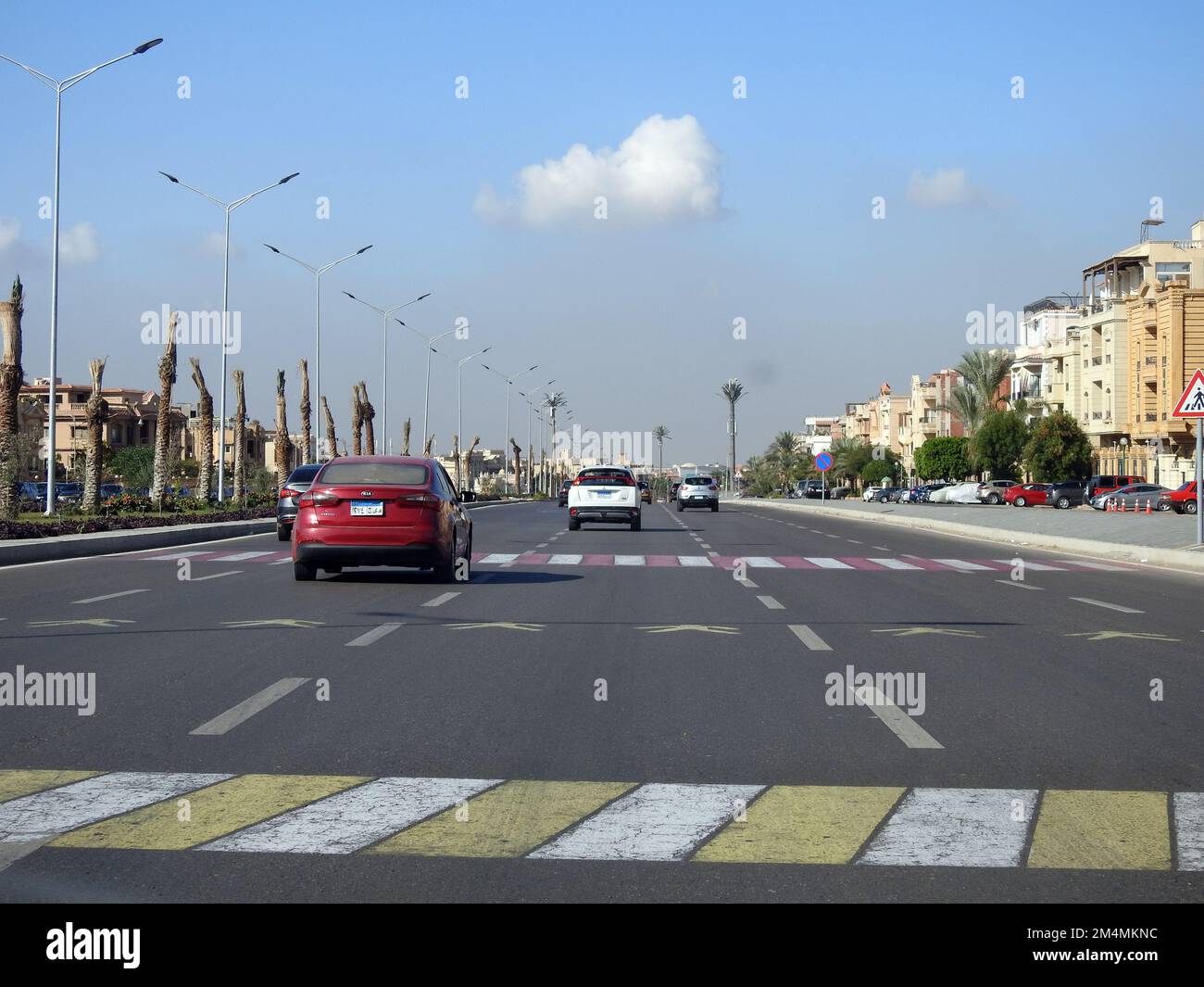 Cairo, Egypt, December 7 2022: Pedestrian crossing area on a highway road axis in Egypt with instructive paint on the asphalt and a road sign to instr Stock Photo