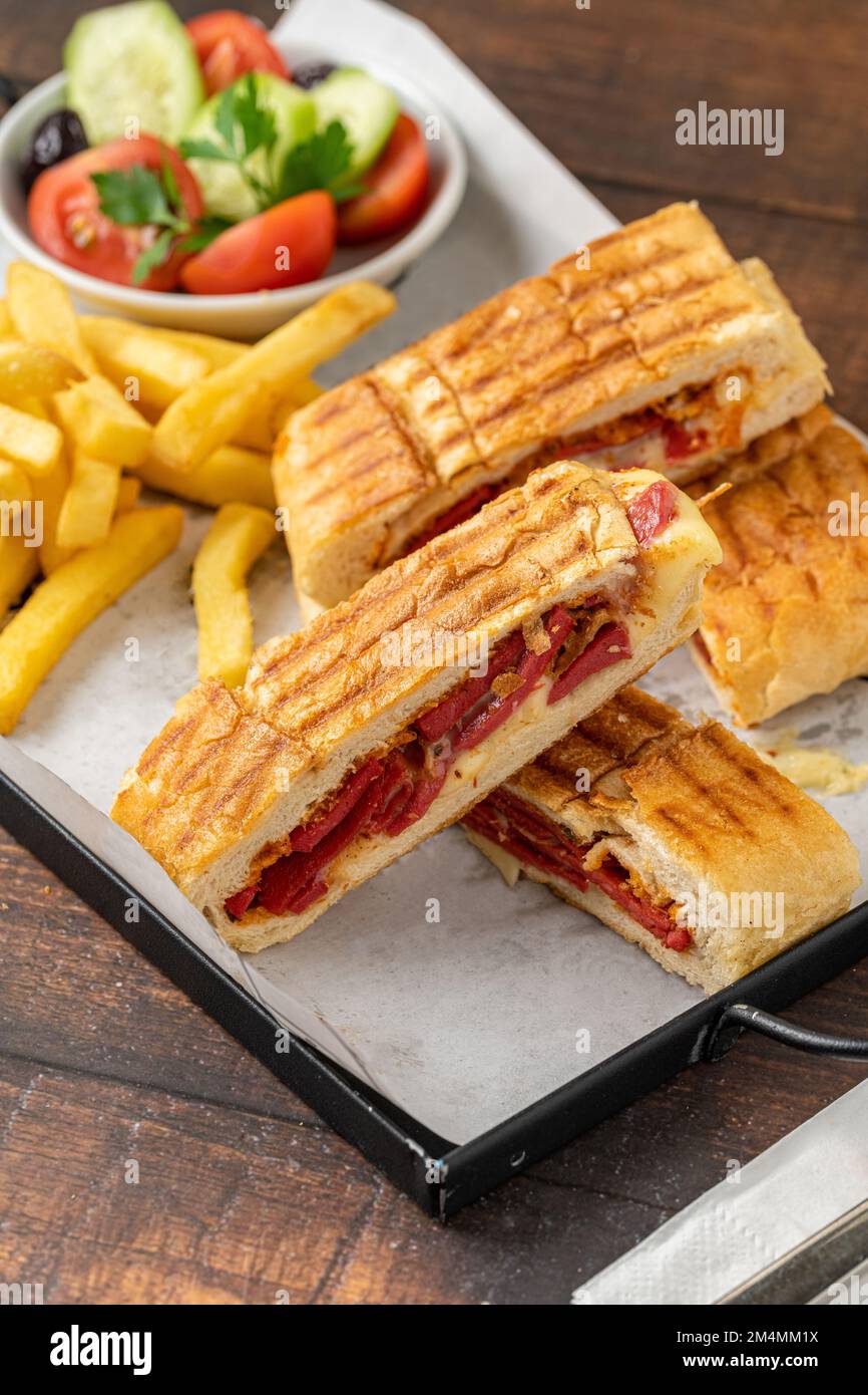 Toast with cheddar cheese and turkish sausage with french fries and