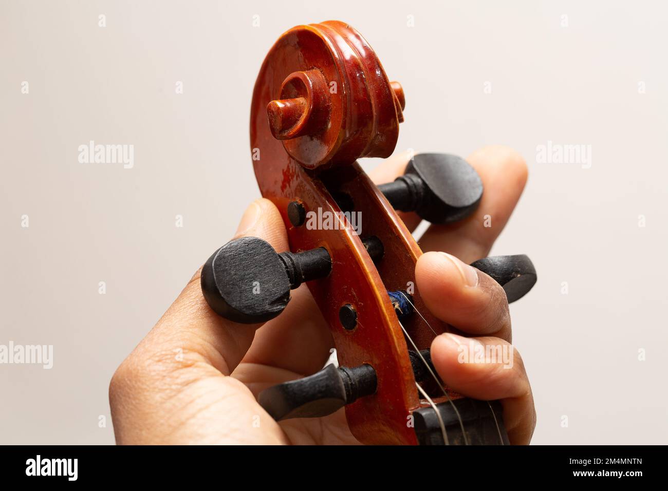 Close up view hand on Musical instrument acoustic guitar headstock