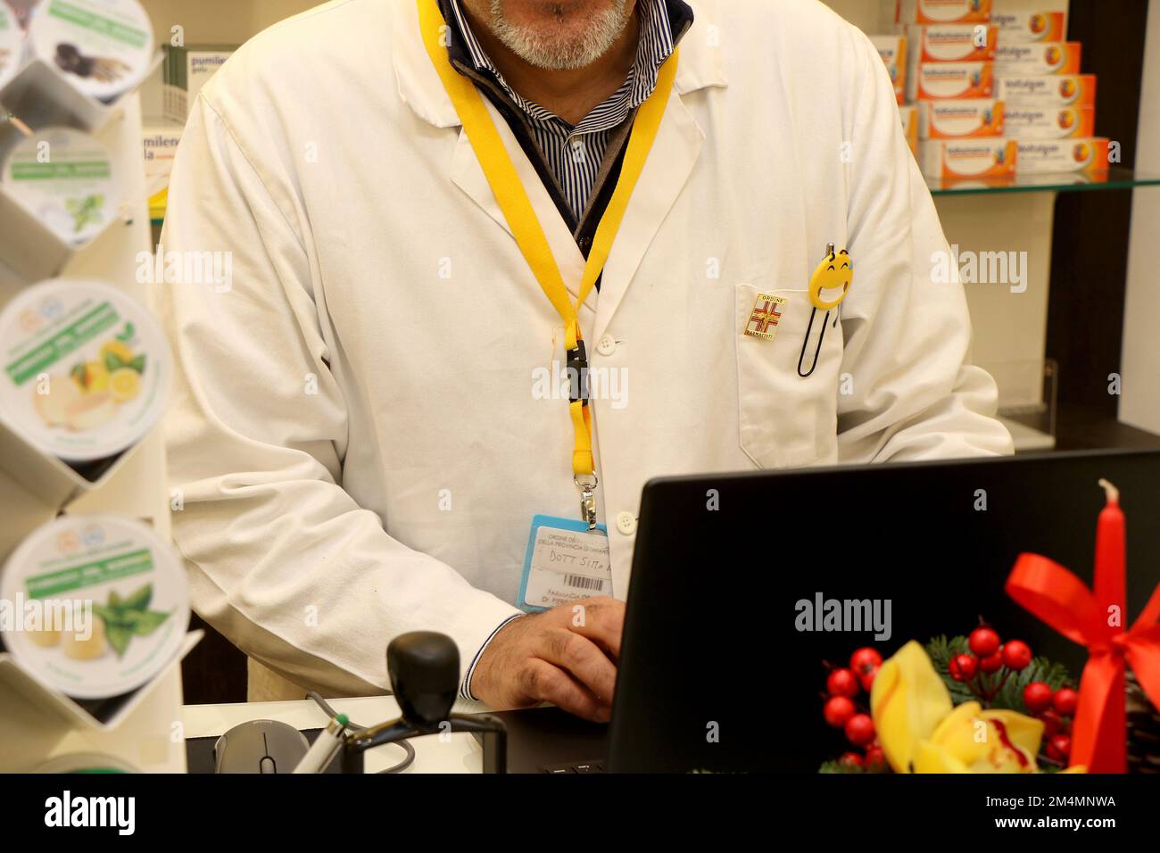 Pharmacist behind the counter of an Italian pharmacy. High quality photo Stock Photo