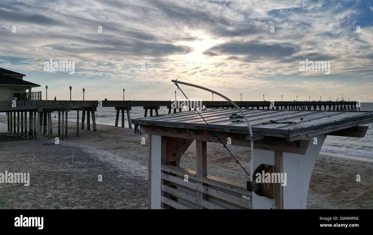 A beautiful sunset over a pier in the sea Stock Photo - Alamy