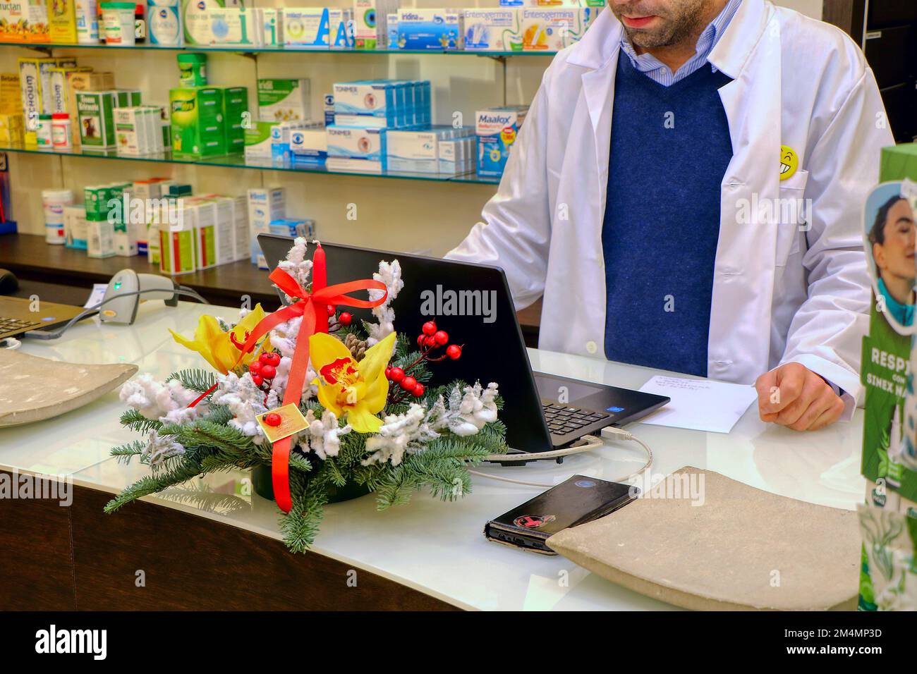 Pharmacist behind the counter of an Italian pharmacy. High quality photo Stock Photo