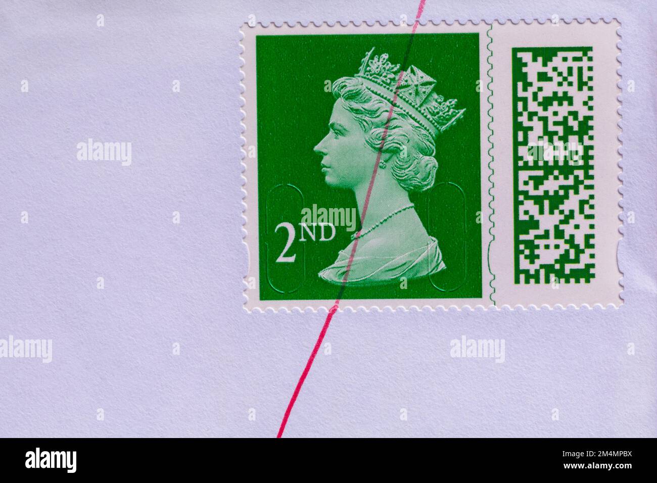 green 2nd class stamp with Queen Elizabeth II head, stuck on envelope