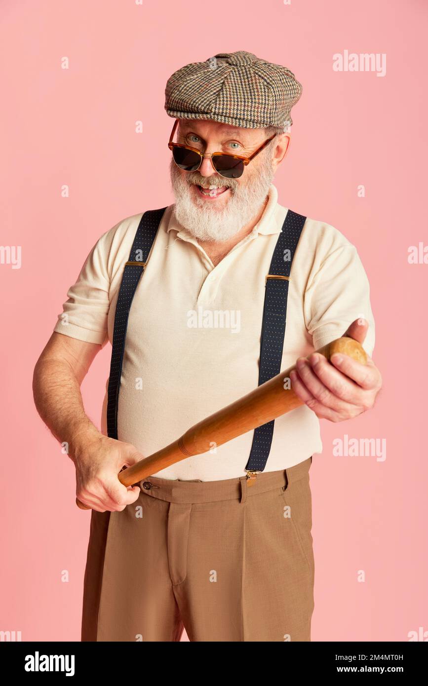 Portrait of senior man in classical clothes, cap, suspenders and