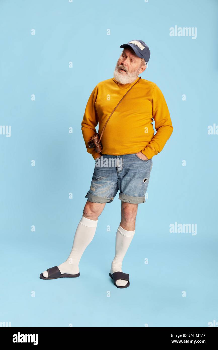 Portrait of senior bearded man in casual clothes with cap and vintage ...