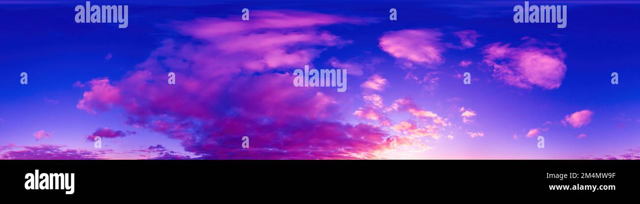 Panorama of a dark blue sunset sky with golden Cumulus clouds. S Stock ...