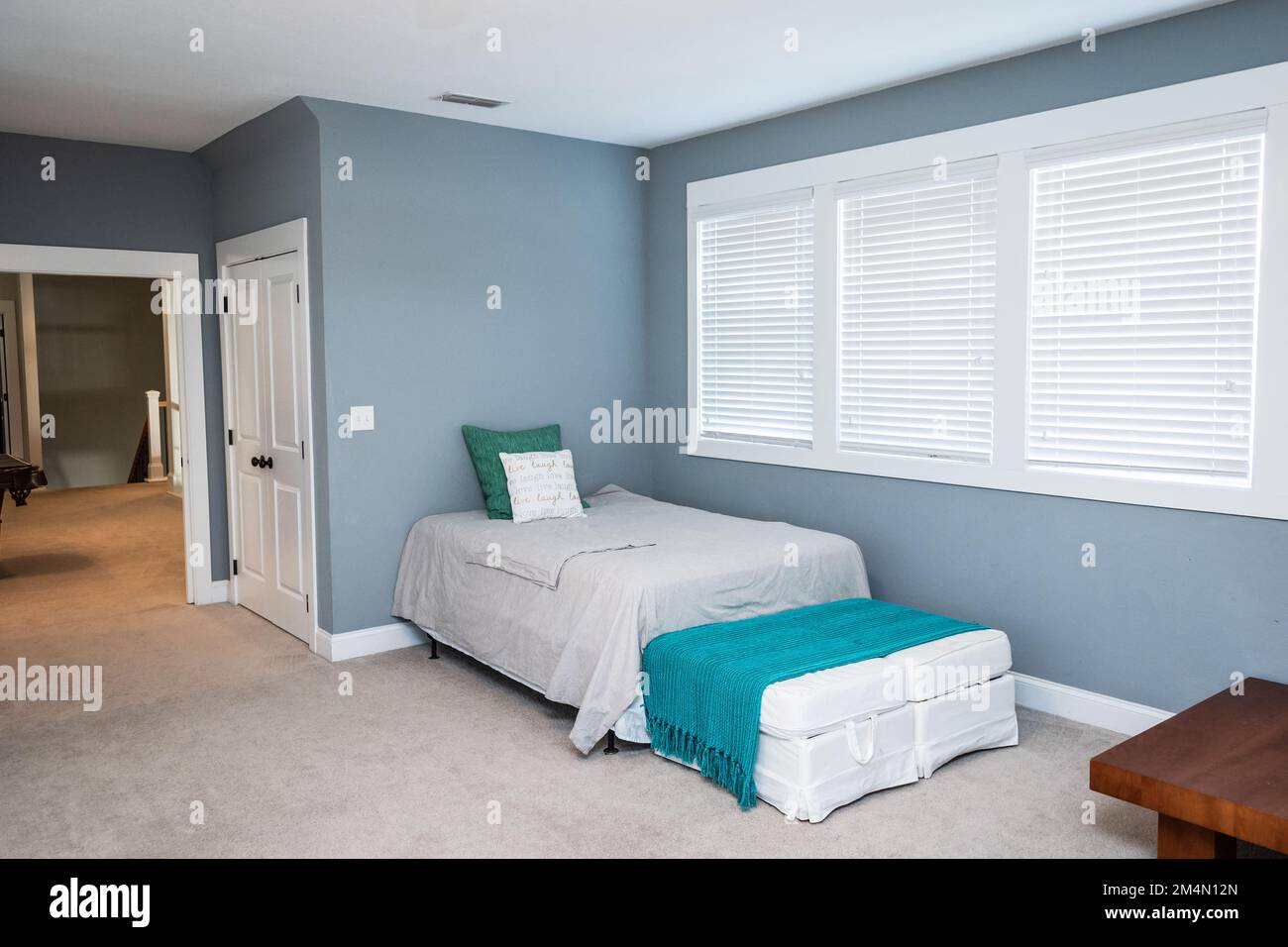 An extra bed for guests in a new construction upstairs bonus room Stock Photo