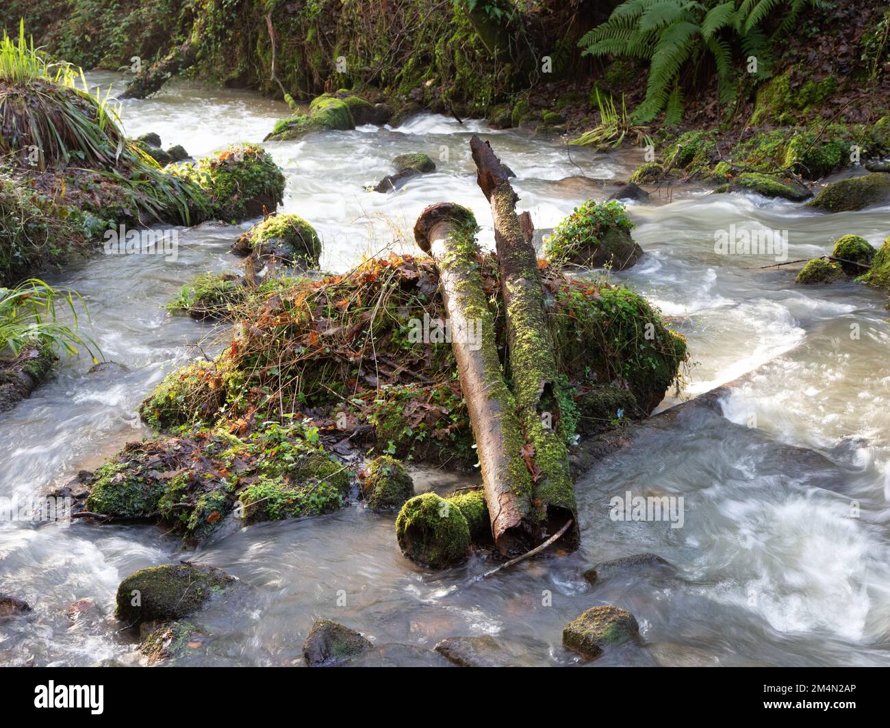 Rusty corroding pipe in a stream Stock Photo