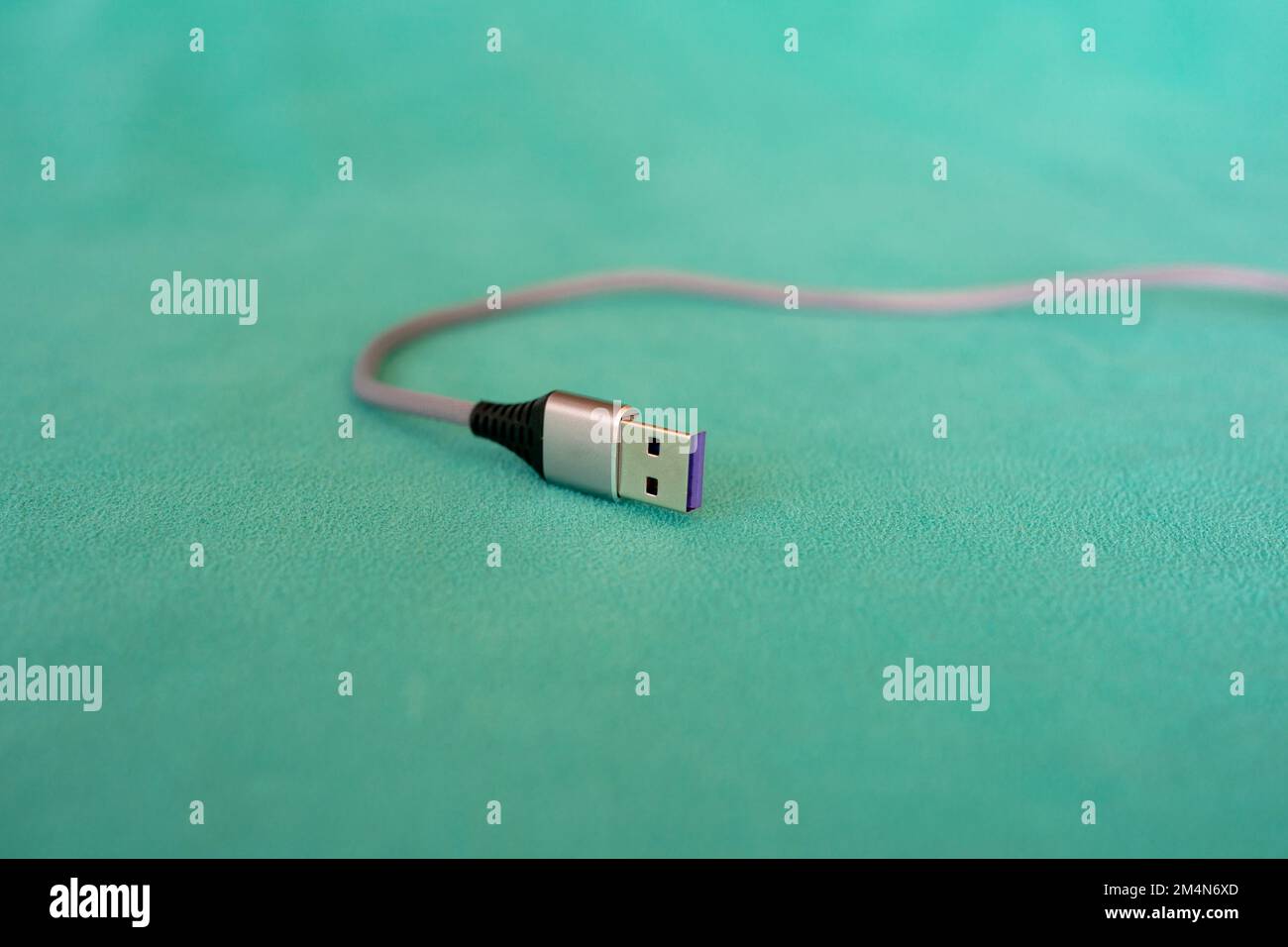 USB cable isolated on green background Stock Photo