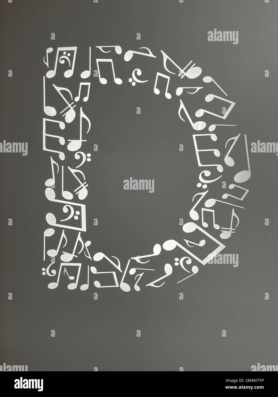 A vertical digital illustration of musical notes in the form of the letter D Stock Photo