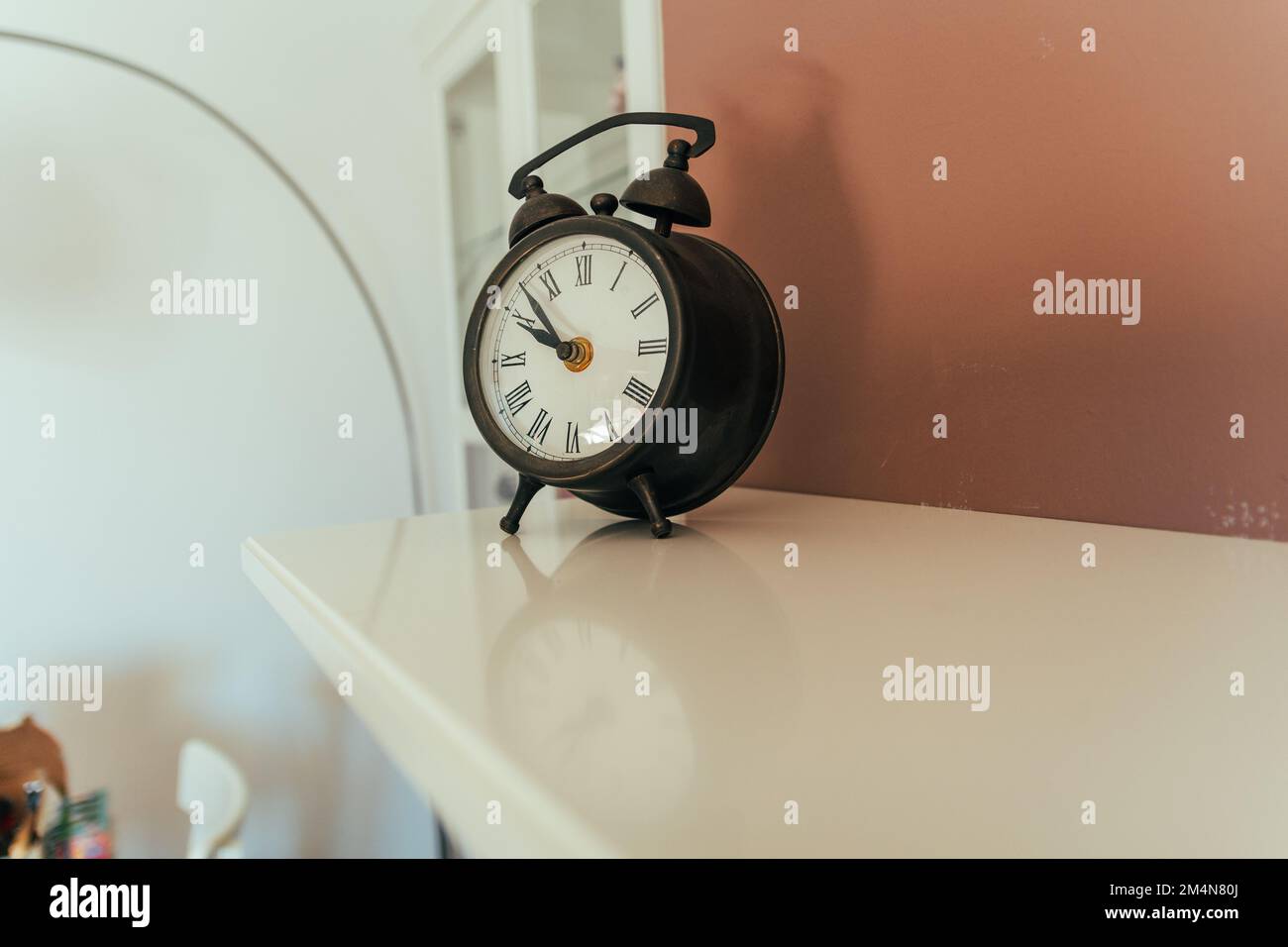 Alarm clock, vintage. An alarm clock with a linear and classic design. Stock Photo