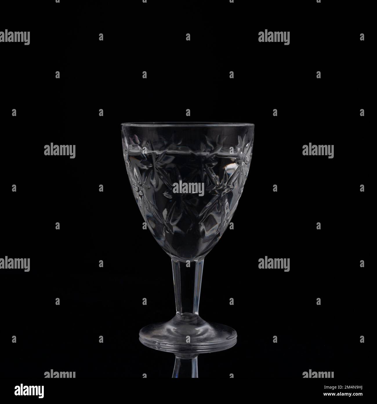 vintage crystal shot glass of vodka on black background. Stock Photo