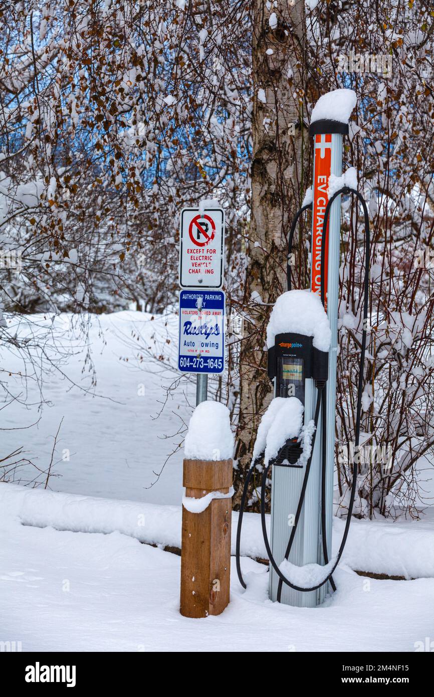 Electric vehicle charging station in winter conditions in Steveston British Columbia Canada Stock Photo