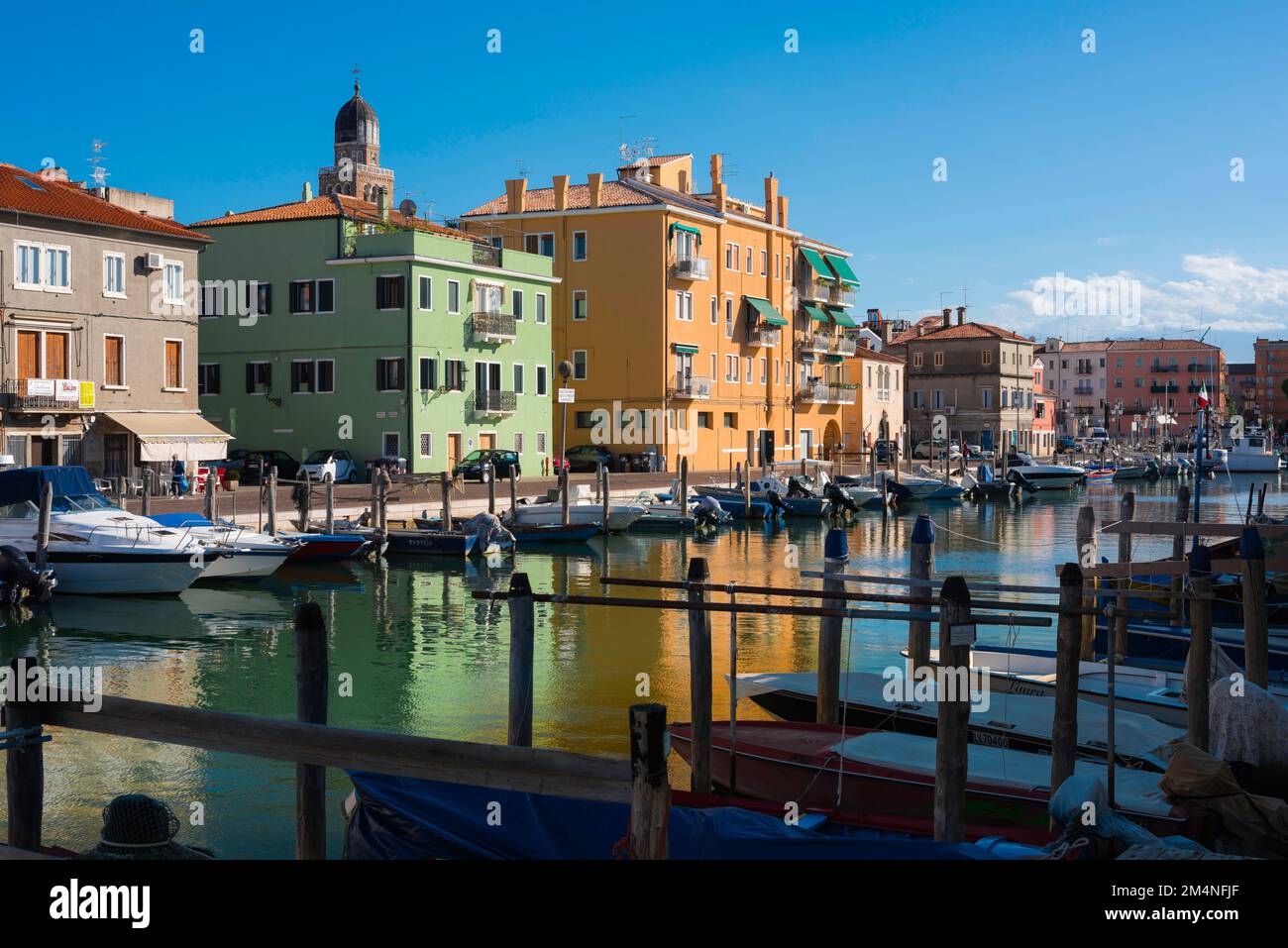 Venice Lagoon Chioggia, view in summer of colorful buildings and fishing boats sited in the Canal Lombardo in Chioggia, Comune of Venice, Veneto Italy Stock Photo
