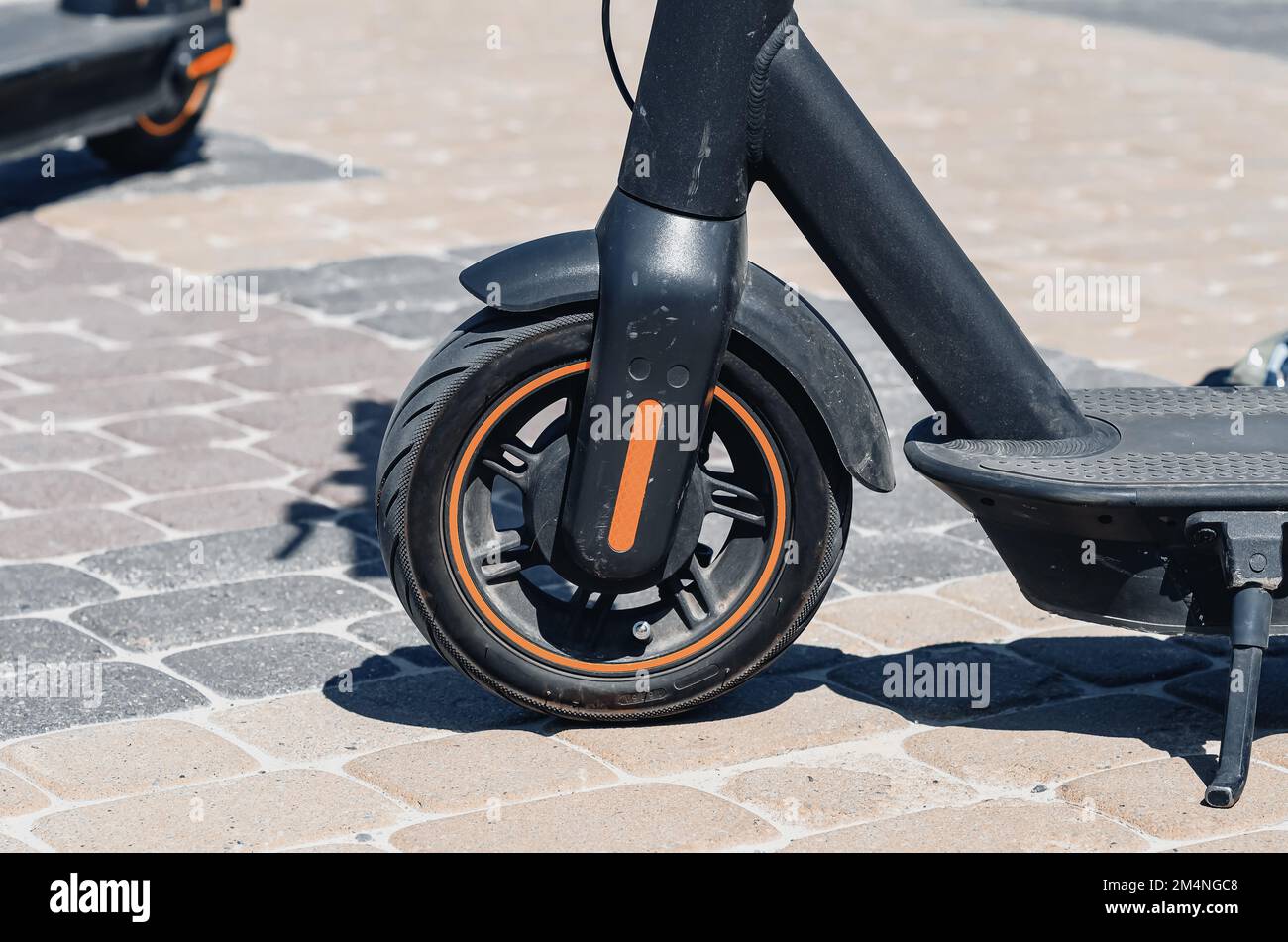 Electric scooter black on the pavement in the city Stock Photo Alamy