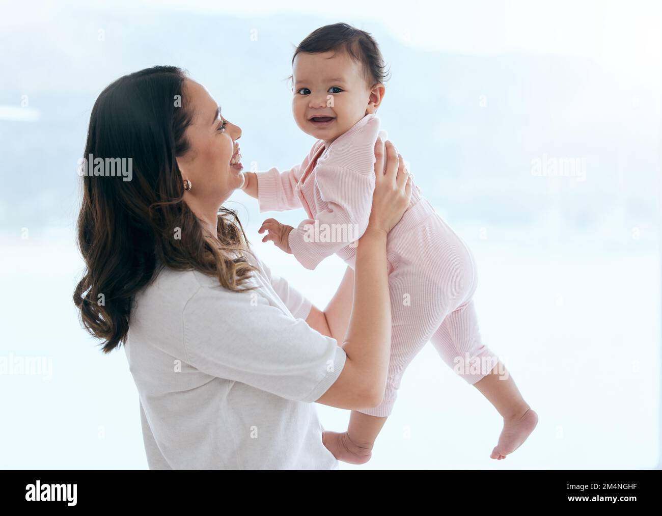 As long as shes happy. a mother holding her baby daughter at home. Stock Photo