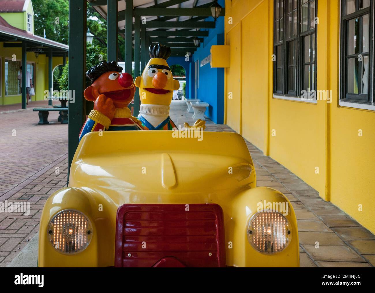 WILLEMSTAD, CURACAO - NOVEMBER 21, 2008: A yellow car for the entertainment of young children and with Sesame Street's muppets Bert and Ernie stands o Stock Photo