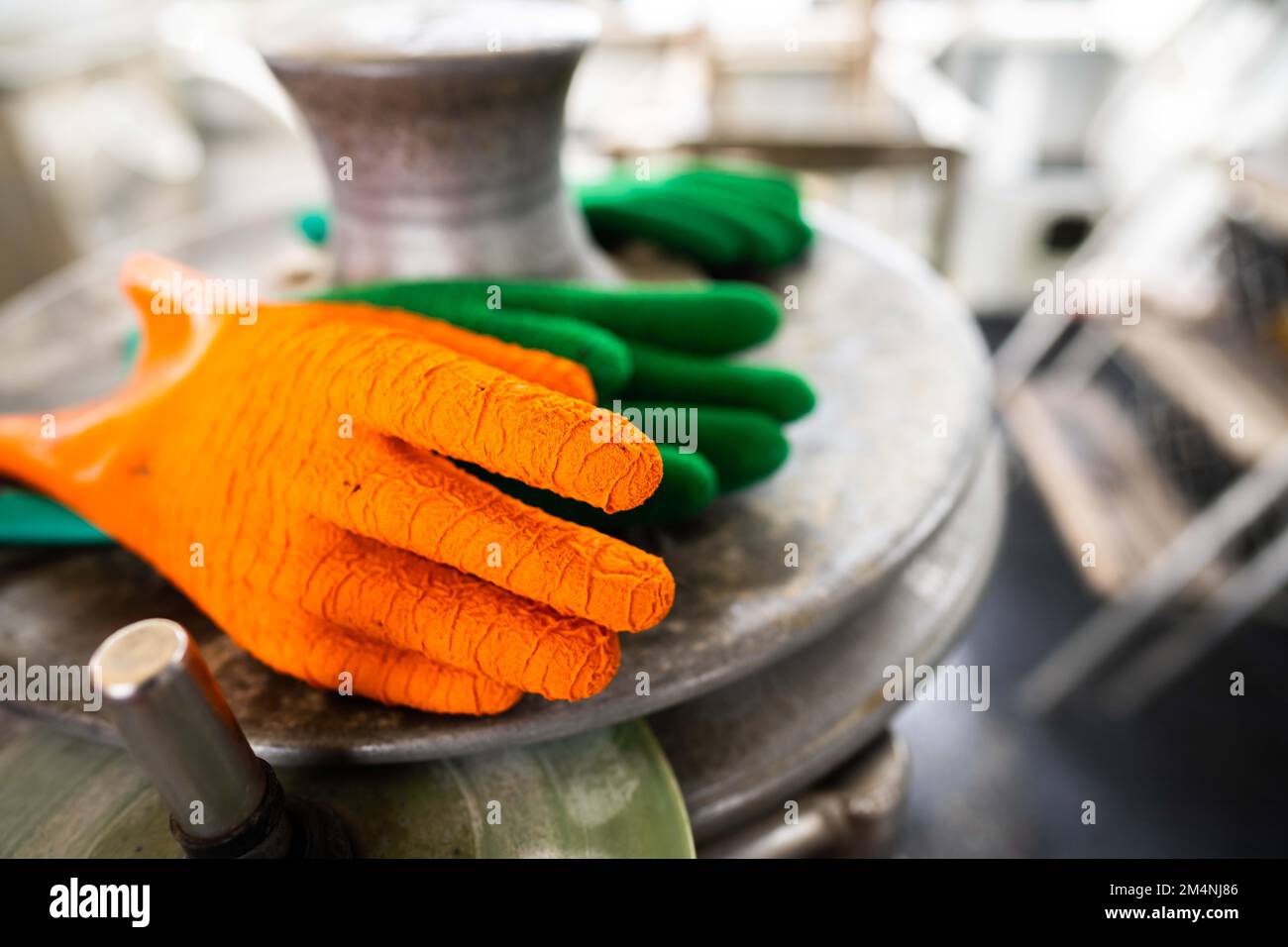 fisherman wearing waterproof clothes and gloves on a fishing boat in