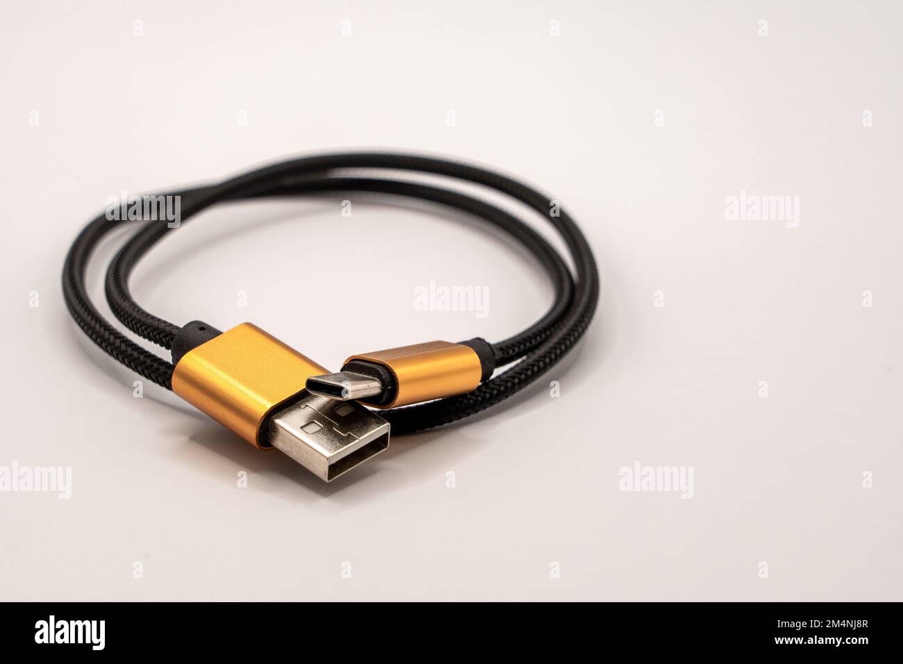 detailed close up of a black braided USB 2 to USB-C male cable with ...
