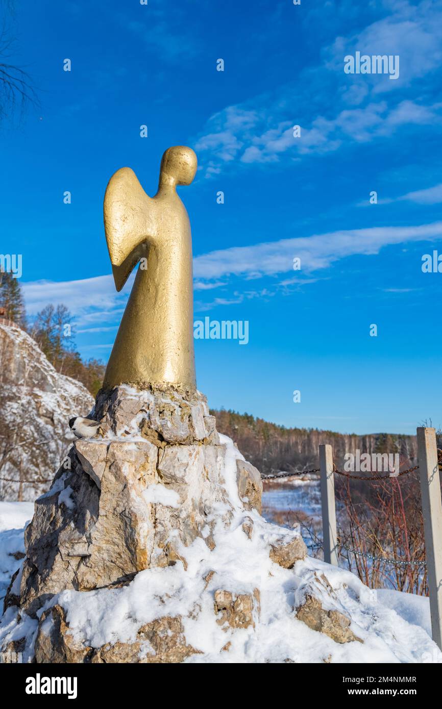 2022.11.27. Statue of the angel of one hope in winter. Serga river in Deer streams national Park. Sverdlovsk region, Ural, Russia. Stock Photo